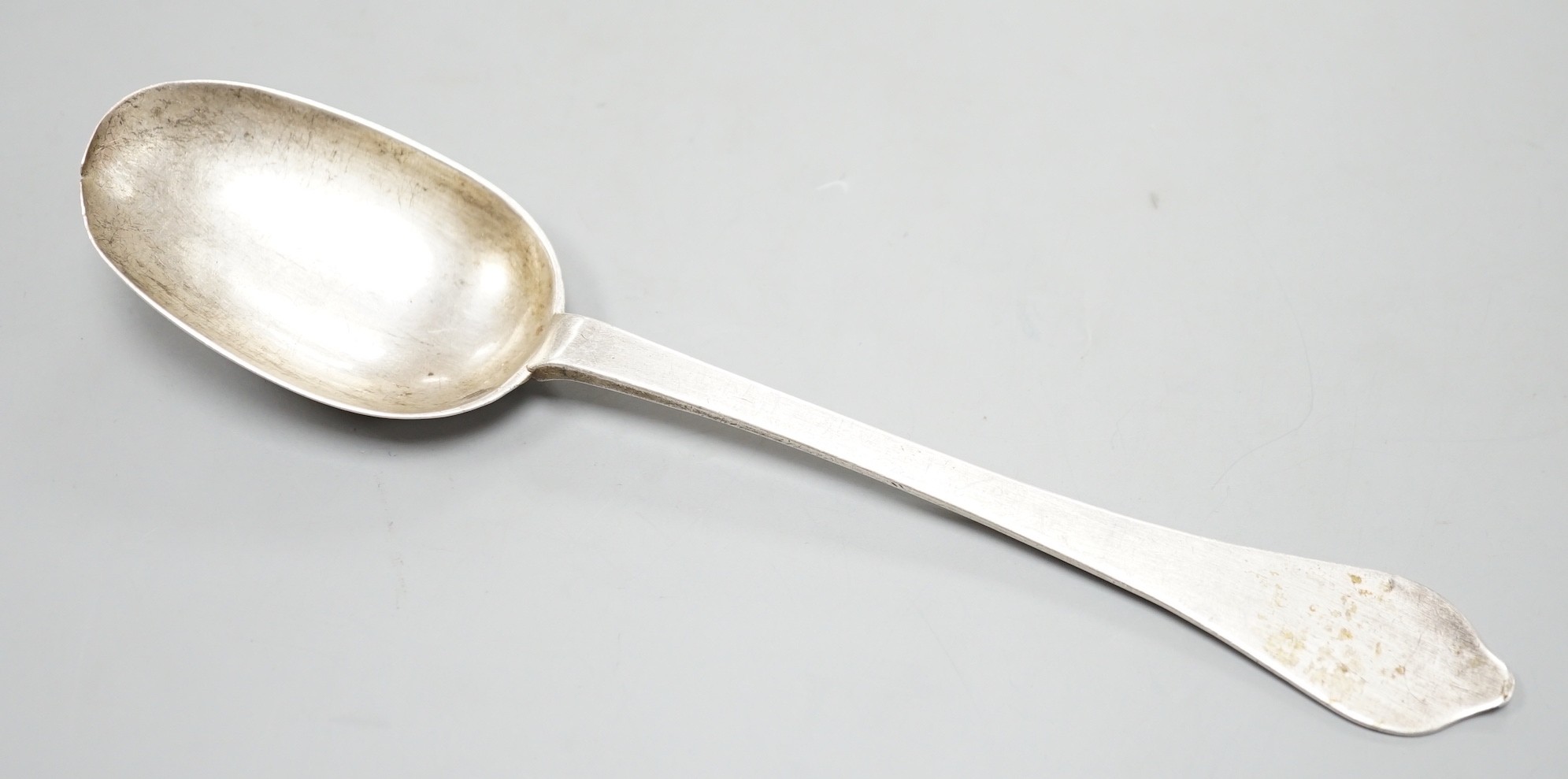 An early 18th century white metal rat tail dog nose spoon, stamped with maker's mark RG below two pellets three times, with prick dot initial and date, 20.6cm, 55 grams.